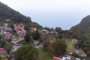 View of houses in a green valley on Saba