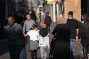 People walking down a shopping street.