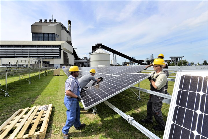 A field full of solar panels is being installed on the site of the GDF-Suez coal-fired power station