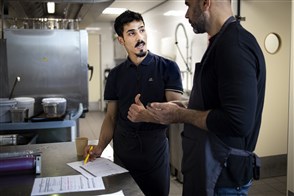 Asylum seekers with residency working in a kitchen